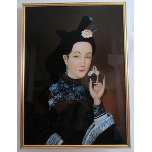 746 - A Chinese reverse painted portrait of a beauty