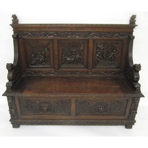 765 - A carved oak hall settle