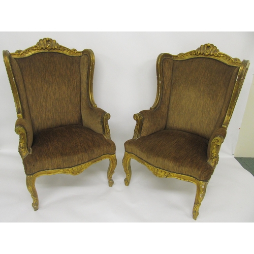 810 - A pair of Victorian gilt gesso wing armchairs