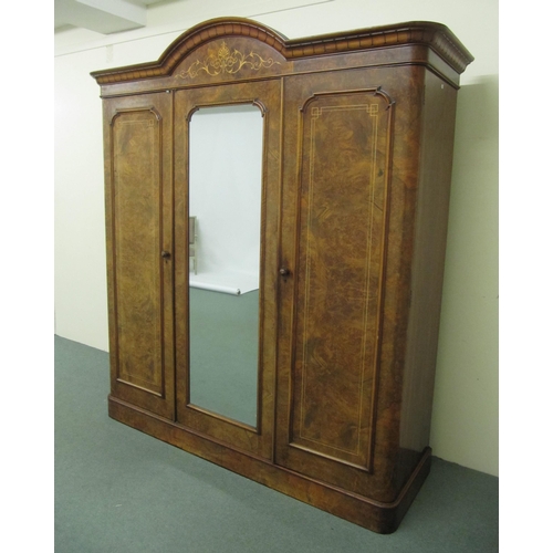 811 - A Victorian walnut triple door wardrobe