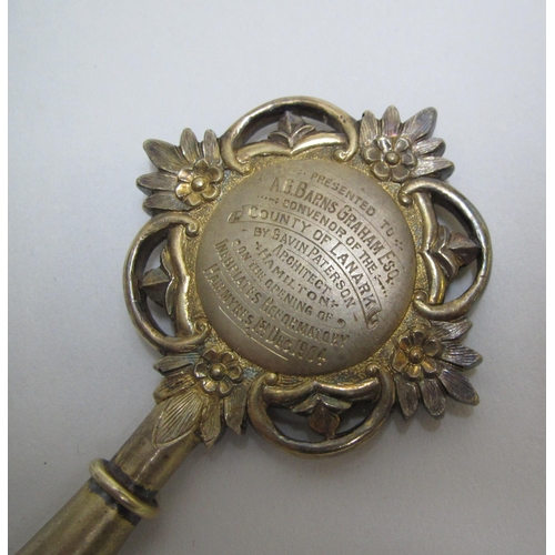 223 - A silver gilt and enamel presentation key