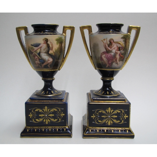 244 - A pair of Royal Vienna style two handled vases on plinths