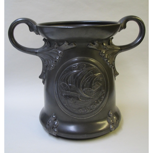 523 - An Arts and Crafts pewter two-handled vase