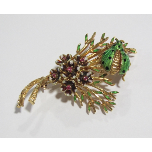 59 - An eighteen carat gold ruby set foliate brooch