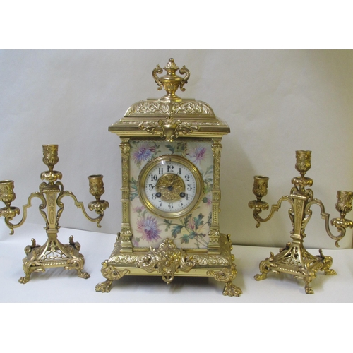 644 - A French brass and porcelain mounted three piece clock garniture