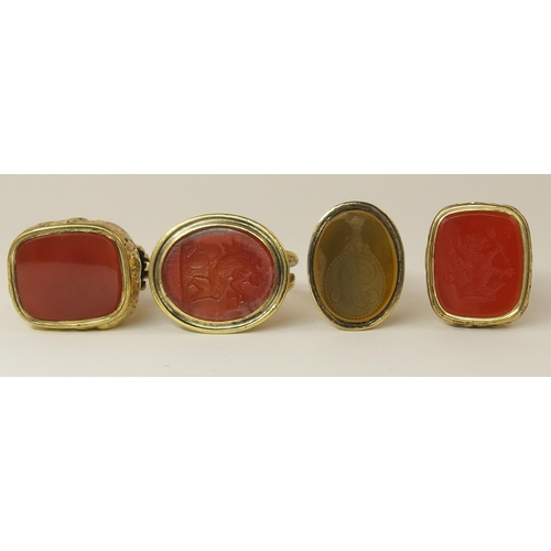 132 - A collection of four yellow metal fob seals