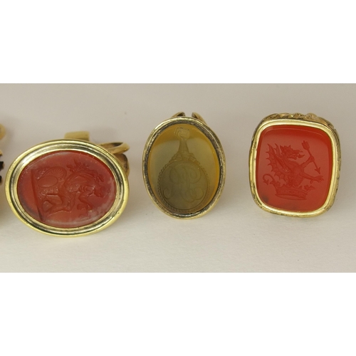 132 - A collection of four yellow metal fob seals