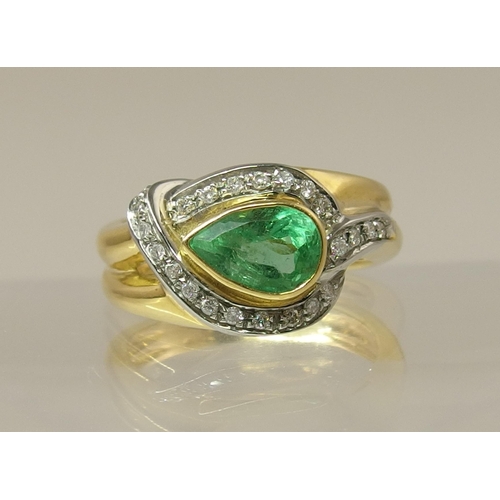 169 - An 18ct emerald and diamond ring