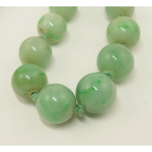 39 - A string of Chinese green hardstone beads