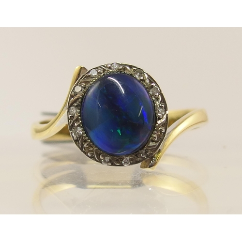 65 - An 18ct black opal and diamond ring