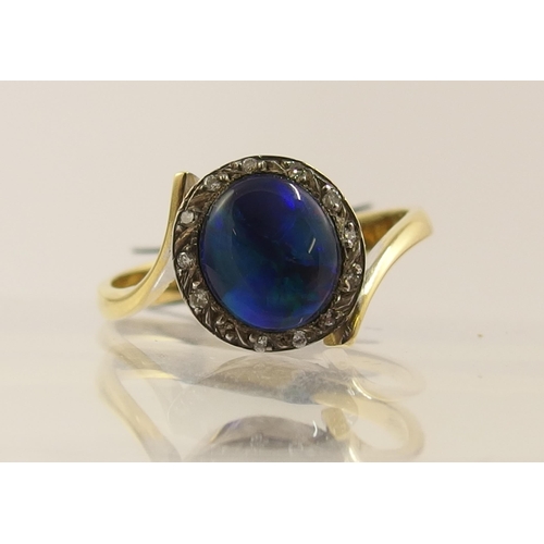 65 - An 18ct black opal and diamond ring