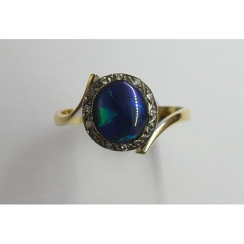 65 - An 18ct black opal and diamond ring