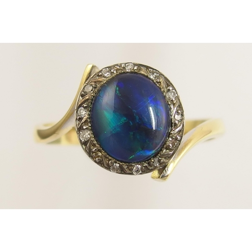 65 - An 18ct black opal and diamond ring