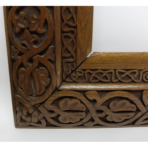 702 - Manner of ALEXANDER RITCHIE an elaborately carved oak picture frame