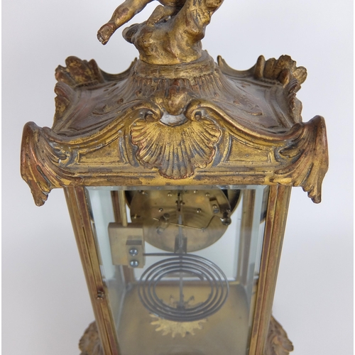 710 - A French Rococo style gilt metal mounted mantle clock