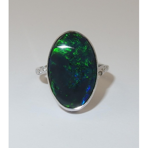 76 - An 18ct white gold ring set with a solid black opal