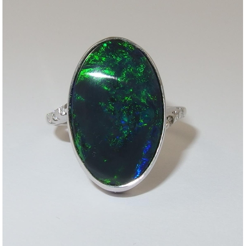 76 - An 18ct white gold ring set with a solid black opal