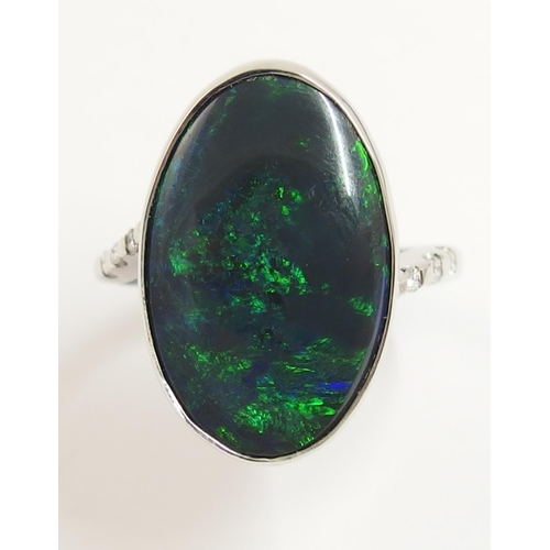 76 - An 18ct white gold ring set with a solid black opal