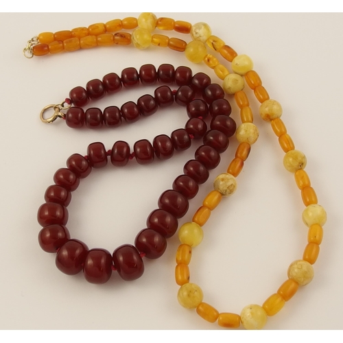 83 - Two strings of amber coloured beads