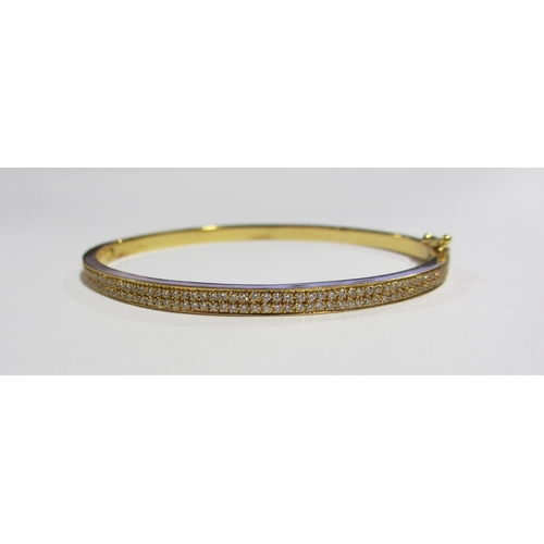 111A - An 18ct gold diamond set bangle