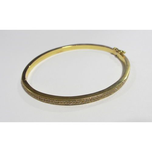 111A - An 18ct gold diamond set bangle