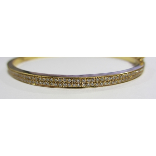 111A - An 18ct gold diamond set bangle