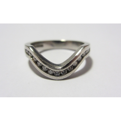 113 - A platinum and diamond half hoop keeper ring