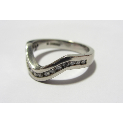 113 - A platinum and diamond half hoop keeper ring