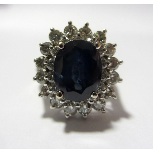 114 - A large sapphire and diamond cluster ring