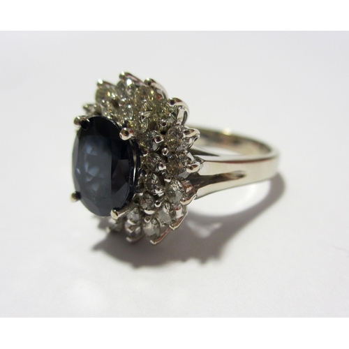 114 - A large sapphire and diamond cluster ring