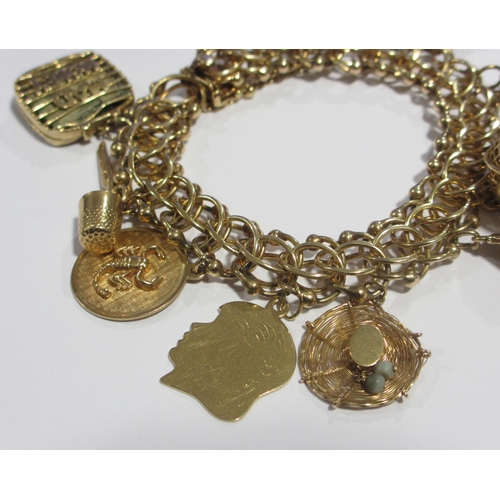 121 - A 14kt gold charm bracelet