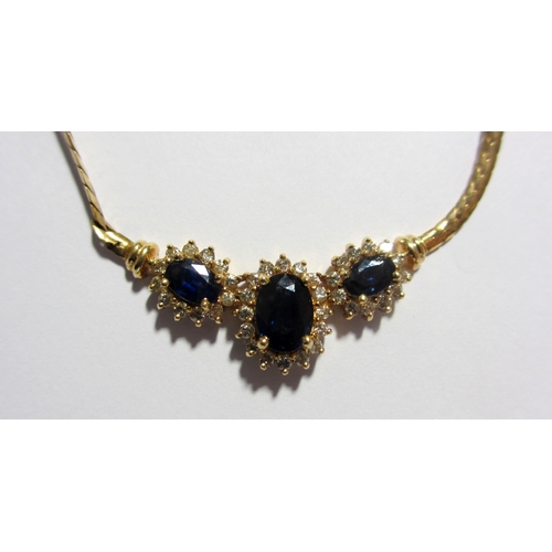 125 - A demi parue of gold  sapphire and diamond jewellery