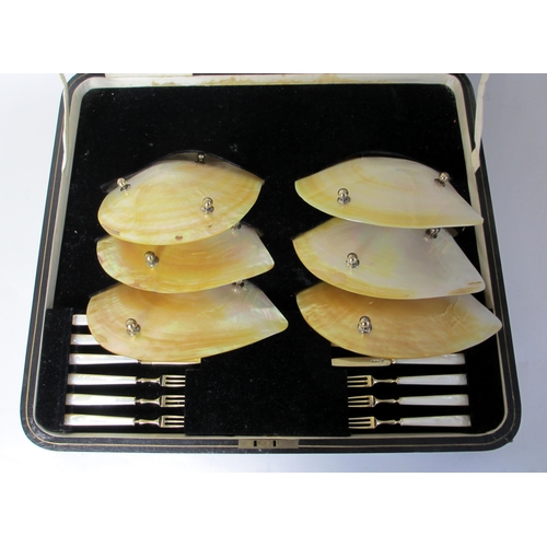 175 - A cased set of six abalone shell fruit dishes