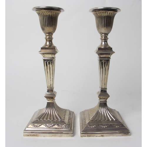 214 - A pair of Victorian silver candlesticks