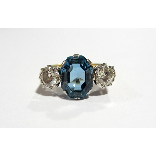 63 - An aquamarine and diamond three stone ring