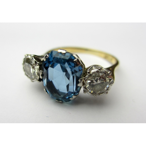 63 - An aquamarine and diamond three stone ring