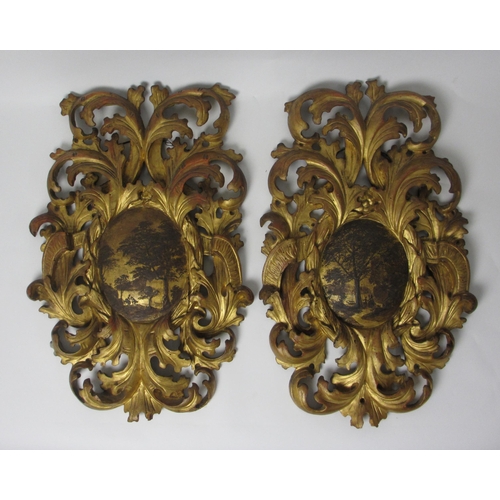 653 - A pair of 18th Century gilt pine pierced foliate cartouches