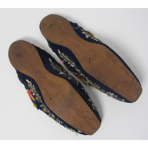 657 - A pair of leather and straw woven moccasins