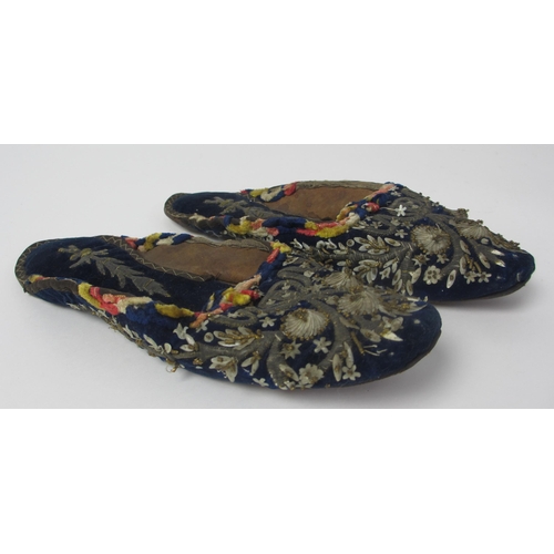 657 - A pair of leather and straw woven moccasins