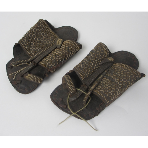 657 - A pair of leather and straw woven moccasins