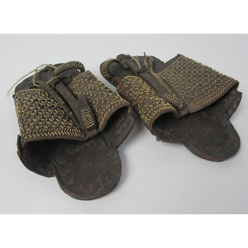 657 - A pair of leather and straw woven moccasins