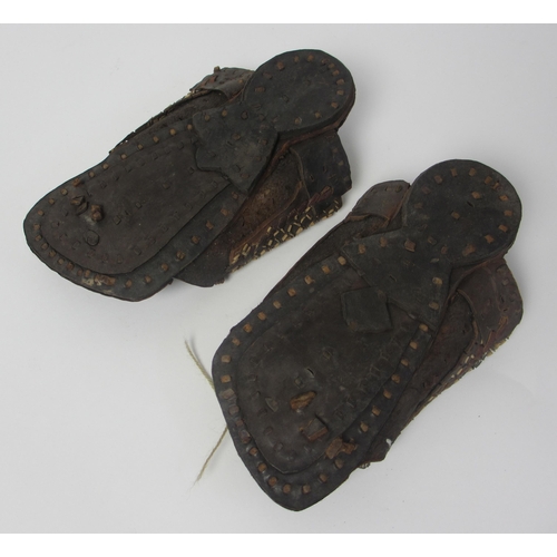 657 - A pair of leather and straw woven moccasins