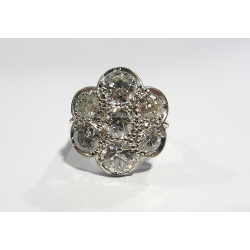 66 - A large daisy head diamond cluster ring