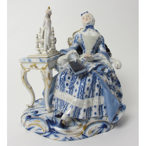 666 - A Meissen figure of a lady sat at her spinning wheel