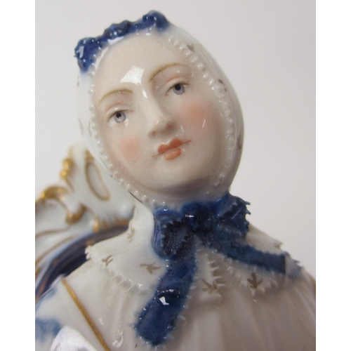 666 - A Meissen figure of a lady sat at her spinning wheel