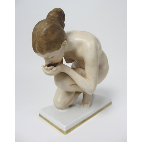 667 - A Rosenthal porcelain figure of a naked woman kneeling