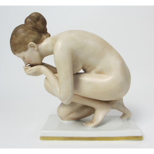 667 - A Rosenthal porcelain figure of a naked woman kneeling