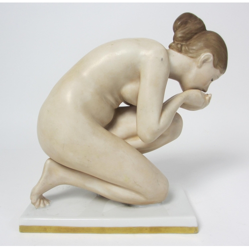 667 - A Rosenthal porcelain figure of a naked woman kneeling