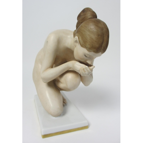 667 - A Rosenthal porcelain figure of a naked woman kneeling