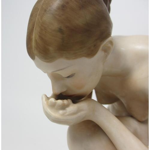 667 - A Rosenthal porcelain figure of a naked woman kneeling